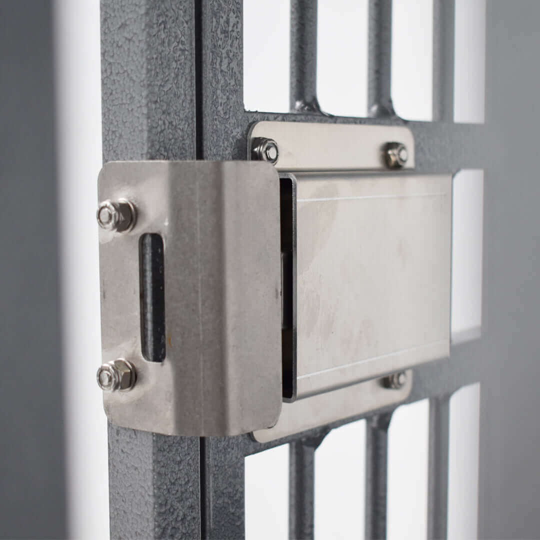 Close-up of the secure latch mechanism on a heavy duty aluminum dog crate by Zinger.